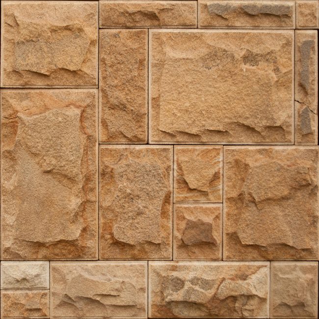 Pierre murale brute aux motifs géométriques et tons terreux pour la conception architecturale.